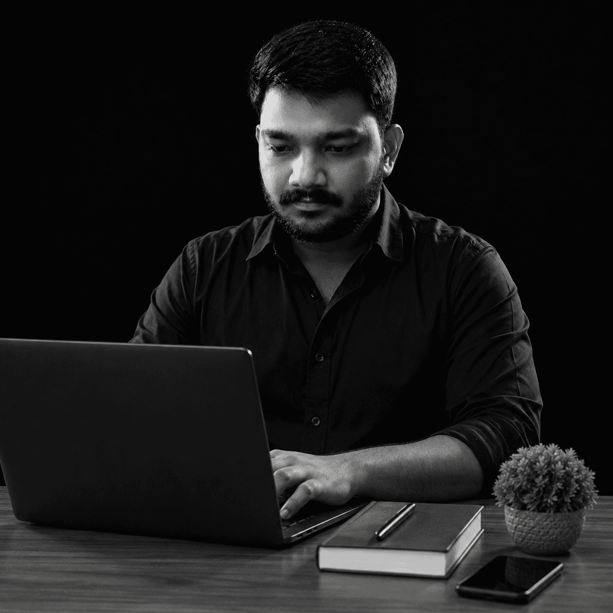 Kamarudheen working on a laptop